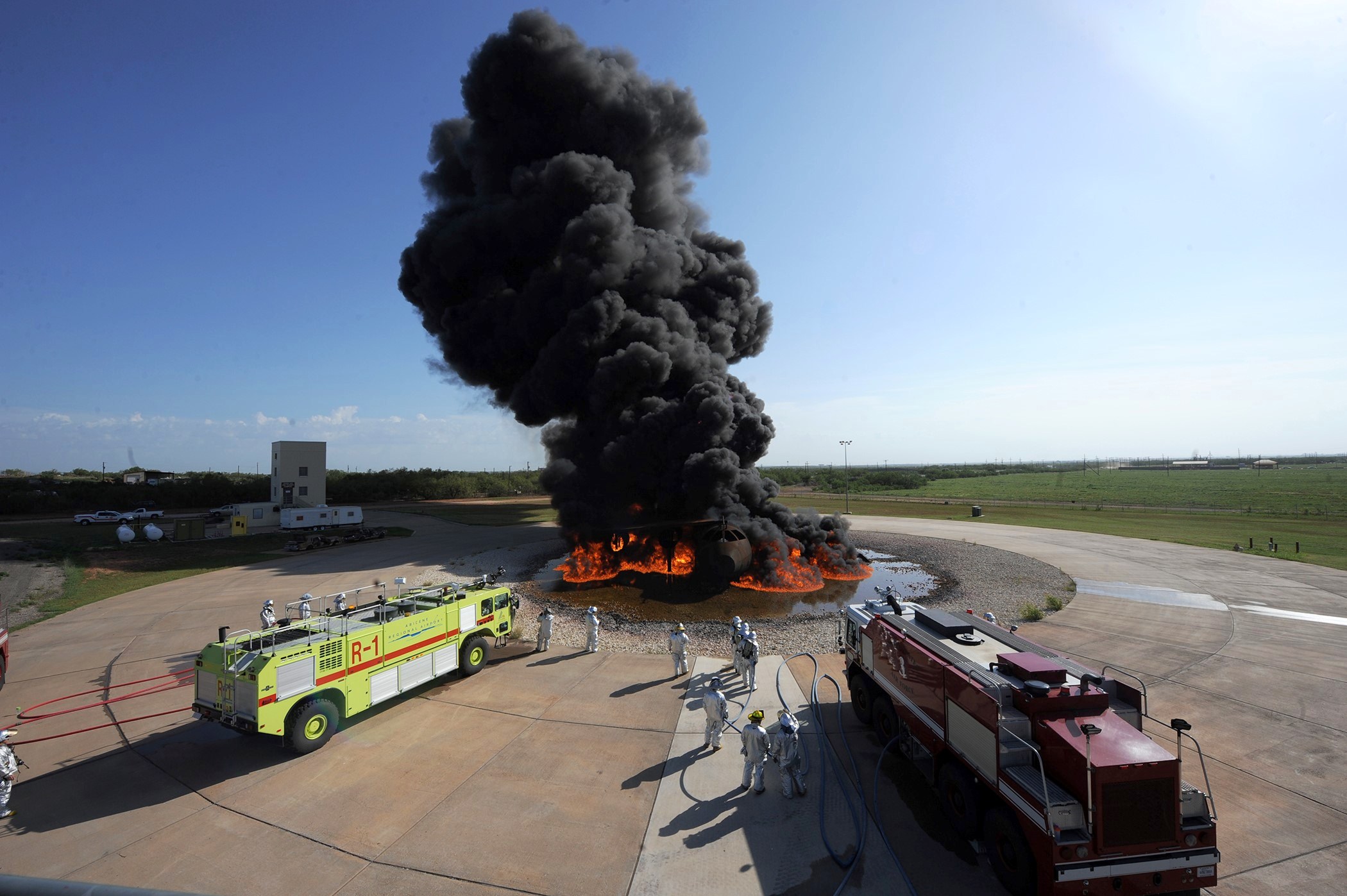 Firefighters putting out a fire at an aircraft firefighter training site